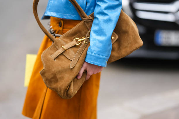 Fay wears a dark brown Miu Miu suede bag, outside Miu Miu, during the Paris Fashion week Women's Fall/Winter 2025-2026 on March 11, 2025 in Paris,...