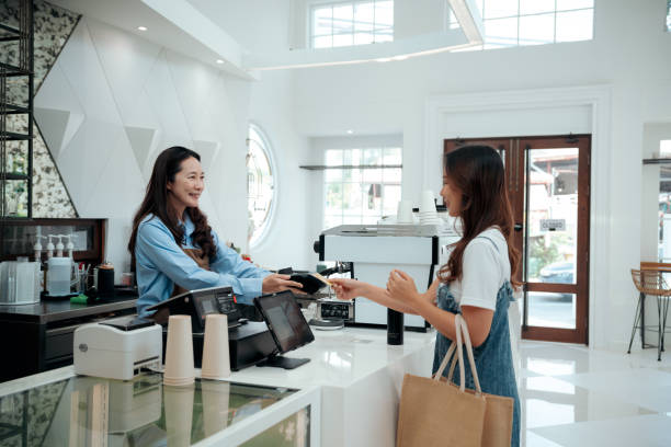 female customer using credit card contactless payment at café - junk food stock pictures, royalty-free photos & images