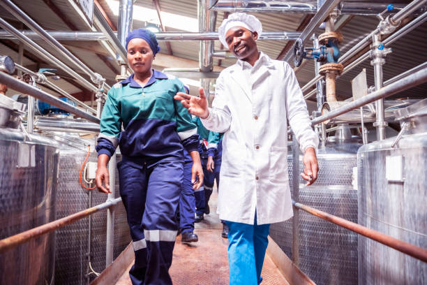 female factory worker walking with her supervisor at a factory - food stock pictures, royalty-free photos & images