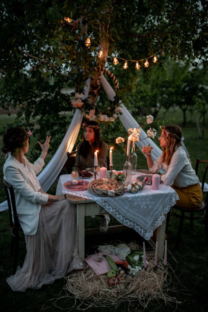 female friends celebrating easter egg hunt outdoors - garden decoration stock pictures, royalty-free photos & images