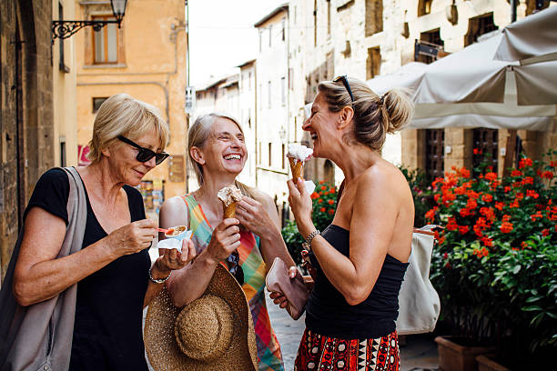 female friends enjoying italian ice-cream - food stock pictures, royalty-free photos & images
