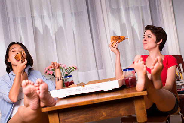 female friends enjoying takeaway pizza - junk food stock pictures, royalty-free photos & images