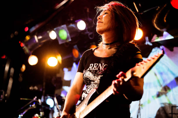 female guitarist - concert stock pictures, royalty-free photos & images