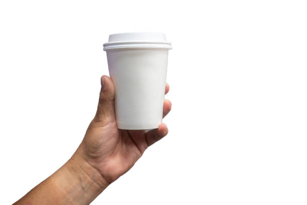 female hand holding a coffee paper cup isolated on white background. - junk food stock pictures, royalty-free photos & images