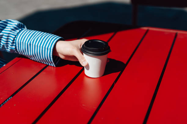 female hand holding recycable takeaway coffee cup - junk food stock pictures, royalty-free photos & images