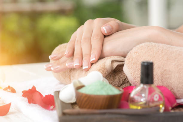 female hands and bowl of spa water with flowers, closeup - nails art stock pictures, royalty-free photos & images