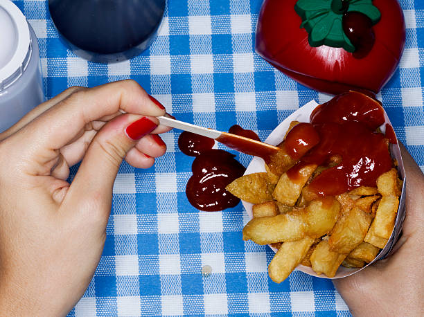 female holding chips with ketchup, messy - junk food stock pictures, royalty-free photos & images