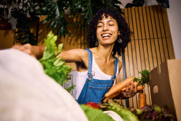 female nutritionist unpacking her reusable shopping bag, enjoying a healthy, plastic-free and eco-friendly lifestyle. - food stock pictures, royalty-free photos & images