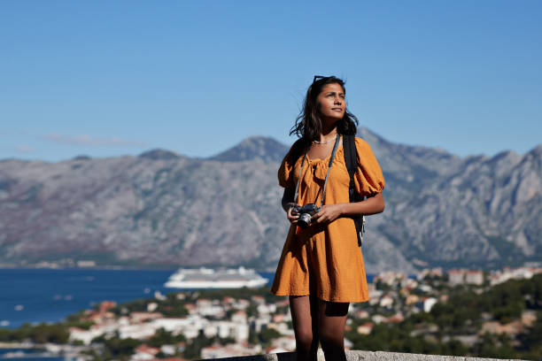 female tourist with camera against mountain range - travel stock pictures, royalty-free photos & images