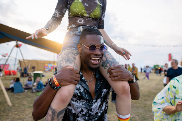 festival shoulder carry - concert stock pictures, royalty-free photos & images