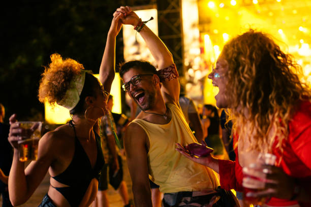 festive friends enjoy at concert - concert stock pictures, royalty-free photos & images