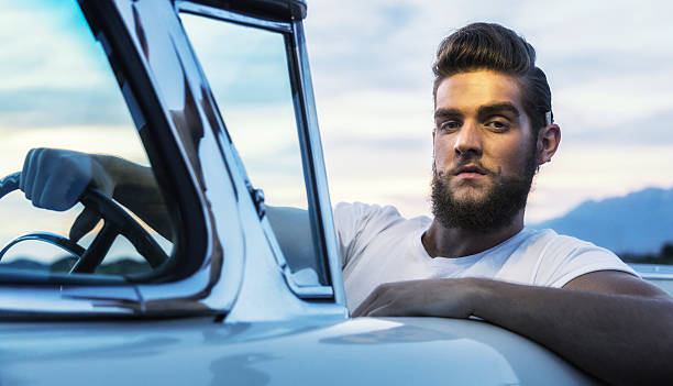 fifties pompadour greaser hipster guy driving classic convertible car - hairstyle stock pictures, royalty-free photos & images