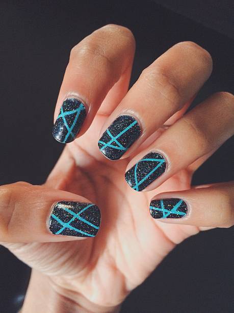 fingernails with nail art on black background - nails art stock pictures, royalty-free photos & images