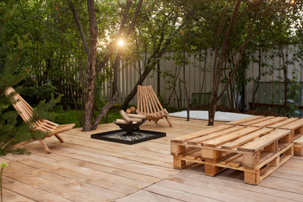 fire place on the wooden veranda next to chairs in garden - garden decoration stock pictures, royalty-free photos & images