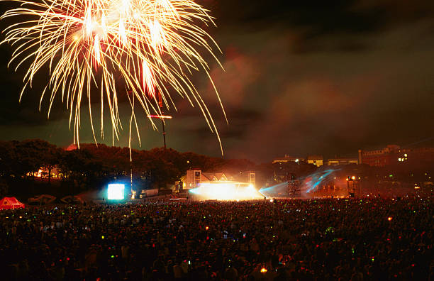 fireworks over auckland domain's concert crowd. - concert stock pictures, royalty-free photos & images