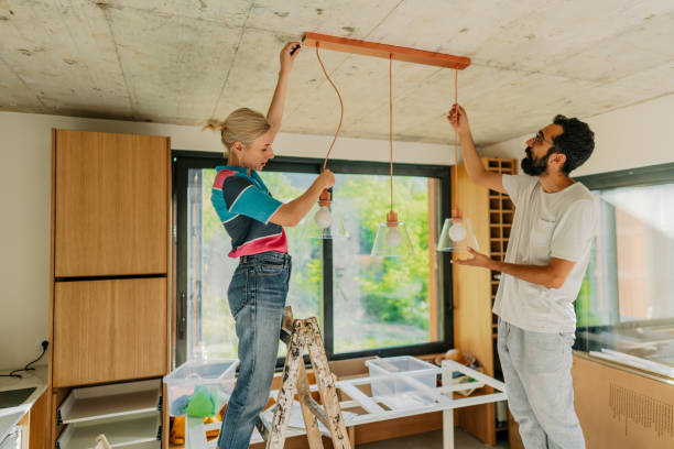 fixing lighting equipment in our home - home decoration stock pictures, royalty-free photos & images