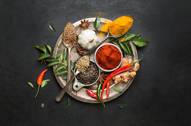 flat lay overhead view herb and spices on textured black background. - food stock pictures, royalty-free photos & images