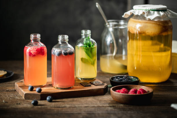flavored kombucha tea bottles in the kitchen - food stock pictures, royalty-free photos & images