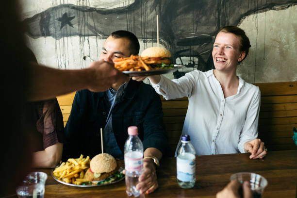 food being served to customers in burger restaurant - food stock pictures, royalty-free photos & images
