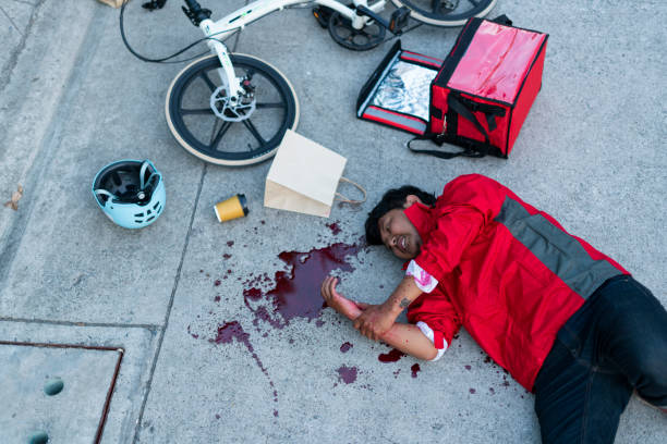 food delivery man bike accident. - junk food stock pictures, royalty-free photos & images