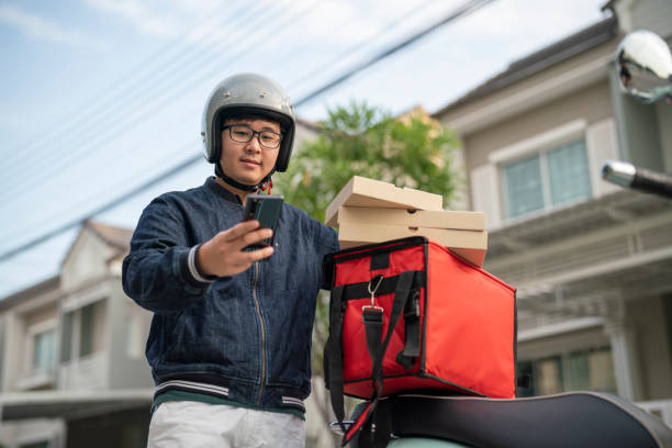 food delivery man getting ready for work - junk food stock pictures, royalty-free photos & images
