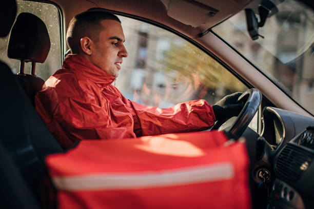 food delivery riding in a car - junk food stock pictures, royalty-free photos & images