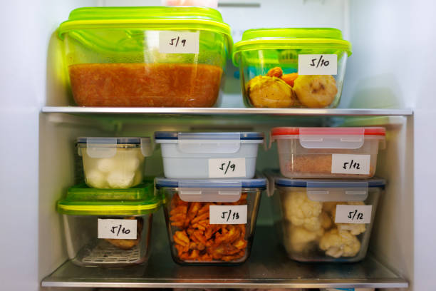 food leftovers packaged in boxes inside a home fridge - food stock pictures, royalty-free photos & images