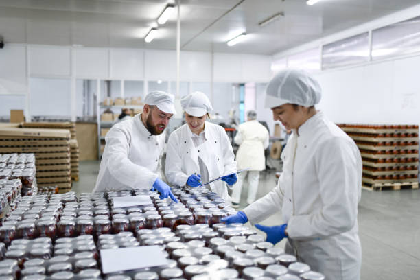 food processing plant warehouse operated by careful workers with jars - food stock pictures, royalty-free photos & images