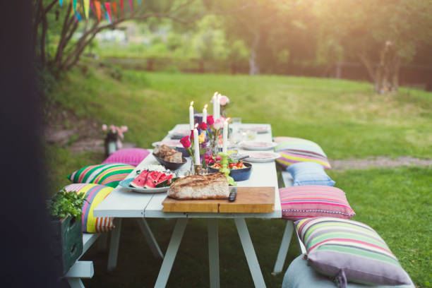 food served on decorated picnic table at back yard during garden party - garden decoration stock pictures, royalty-free photos & images