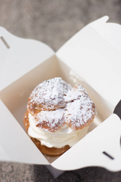 france: big vanilla cream puff in white take-away box - junk food stock pictures, royalty-free photos & images