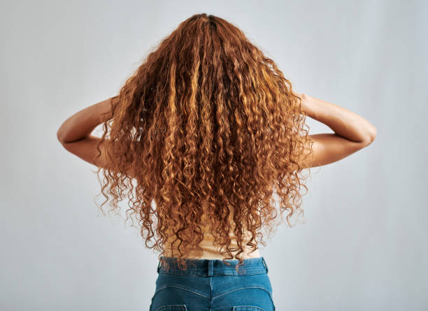 frau mit gesundem, natürlichem und ingwerhaar mit entspannender lockiger, rotbrauner oder roter schönheitsfrisur rückansicht. shampoo salon haarpflege oder rothaariges mädchen, das mit sauberem rotem haar spielt, isoliert auf