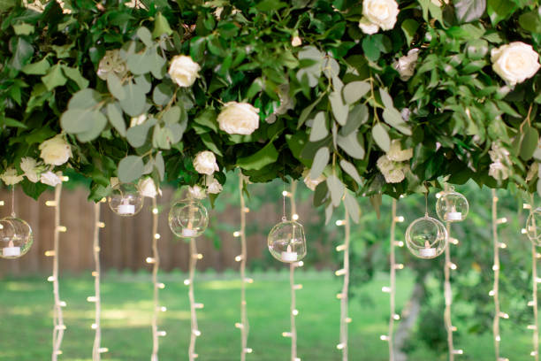 fresh floral garlands with stylish glass candlesticks - garden decoration stock pictures, royalty-free photos & images