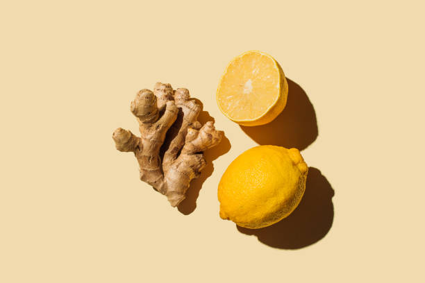 fresh ginger with lemon on beige background. flat lay, top view, copy space. - food photos et images de collection