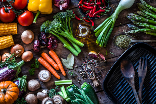 fresh vegetables ready for cooking shot on rustic wooden table - food stock pictures, royalty-free photos & images