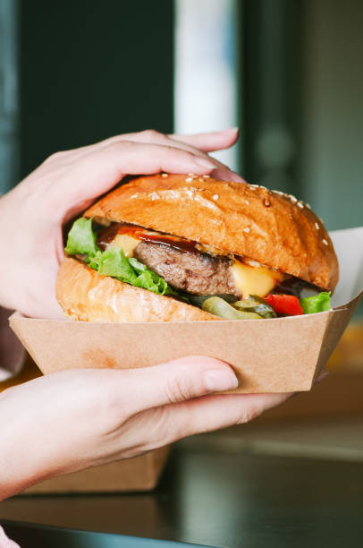 freshly prepared cheeseburger in a paper box - junk food stock pictures, royalty-free photos & images