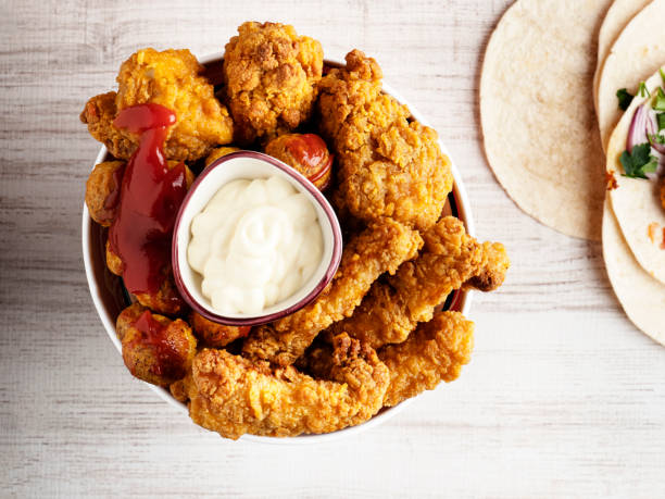 fried chicken strips, fingers and drumstick, crispy fried breaded chicken strips, - junk food stock pictures, royalty-free photos & images