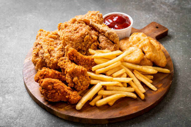 fried chicken with french fries and nuggets meal - food photos et images de collection