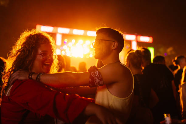 friends bonding at concert - concert stock pictures, royalty-free photos & images