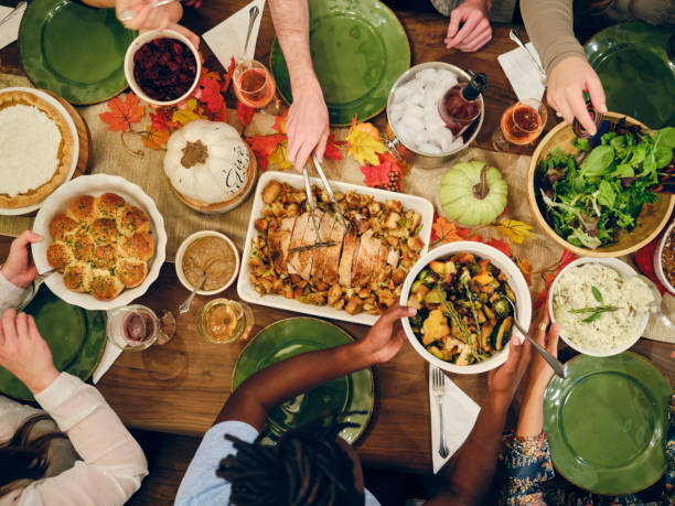 friends celebrating thanksgiving dinner together - food stock pictures, royalty-free photos & images