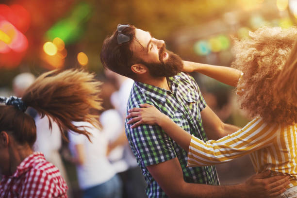 friends dancing at a concert. - concert stock pictures, royalty-free photos & images