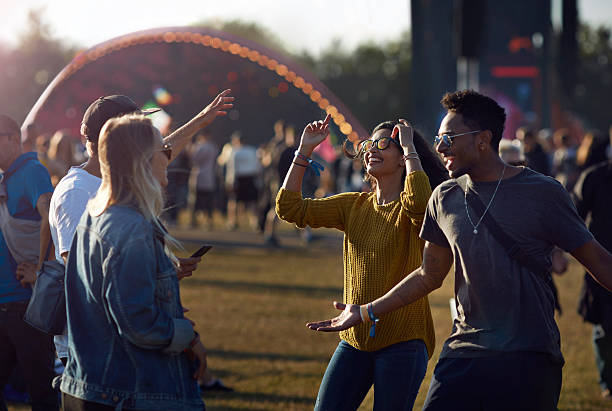 friends dancing at concert outside - concert stock pictures, royalty-free photos & images