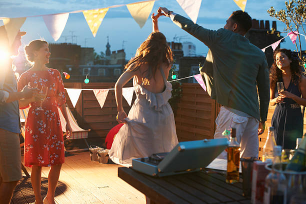 friends dancing at early evening party - garden decoration stock pictures, royalty-free photos & images