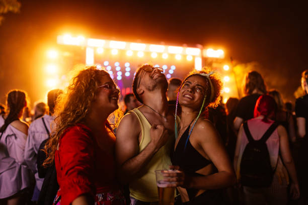 friends drinking beer and having fun at music festival. - concert stock pictures, royalty-free photos & images