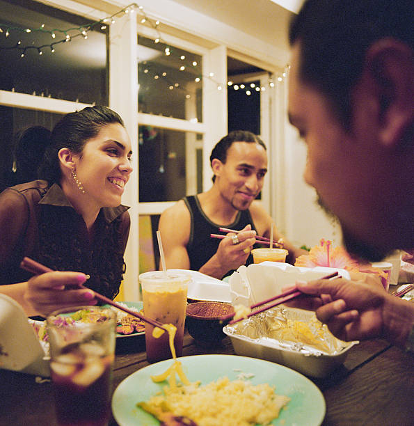 friends eating asian takeout - junk food stock pictures, royalty-free photos & images
