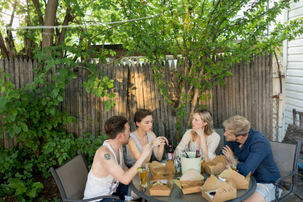 friends eating at a party - junk food stock pictures, royalty-free photos & images