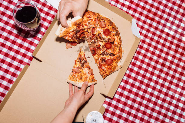 friends eating pizza at home - food stock pictures, royalty-free photos & images