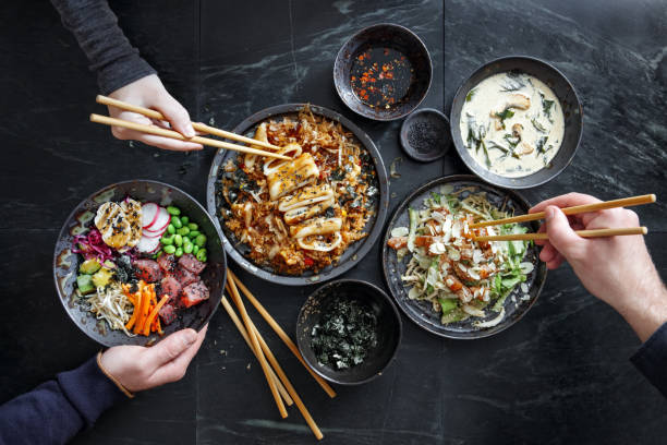 friends eating tradition japanese dishes - junk food stock pictures, royalty-free photos & images