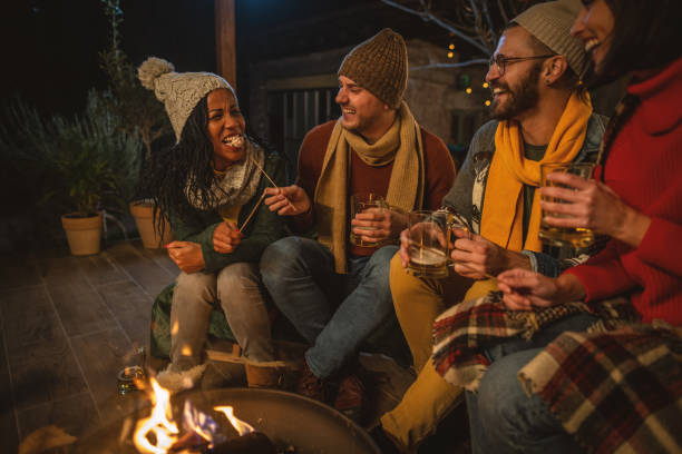 friends enjoy in winter night at porch - garden decoration stock pictures, royalty-free photos & images