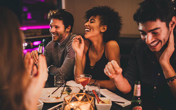 friends enjoying a meal - food stock pictures, royalty-free photos & images