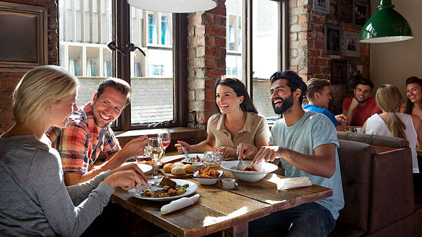 friends enjoying a meal - food stockfoto's en -beelden